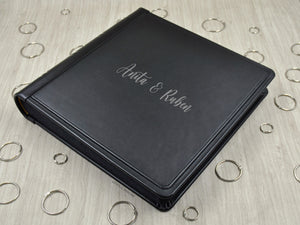 example of matte silver vinyl personalization on a black leather cover of a photo album by Giovelli Design