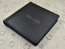 Carica l&#39;immagine nel visualizzatore di Gallery, example of matte gold vinyl personalization on a black leather cover of a photo album by Giovelli Design
