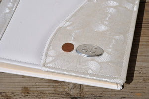 measurements of a bilaminated silver plaque on a white photo album by Giovelli Design