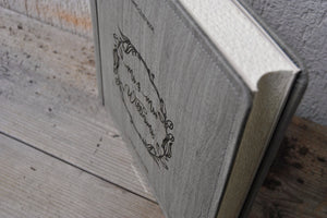 picture from above of a rustic grey wedding guestbook album by Giovelli Design