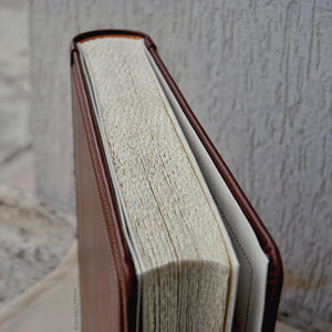 white pages of a medium brown leather album