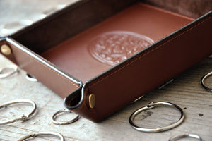 particular of stylish finishes on a classic brown leather valet tray