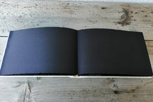 Carica l&#39;immagine nel visualizzatore di Gallery, opened album with black pages
