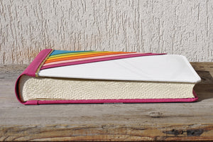 white wedding photo album with a colorful handcrafted rainbow by Giovelli Design