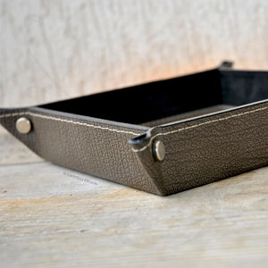 particular of fancy finishes and metal studs on a leather valet tray by Giovelli Design